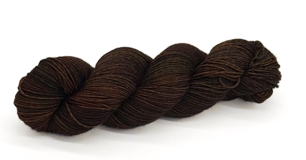 A skein of yarn with rugged warm browns reminiscent of bark and leather.