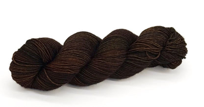 A skein of yarn with rugged warm browns reminiscent of bark and leather.