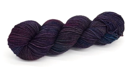 A skein of yarn blending fiery burgundy, ruby and wine shades.