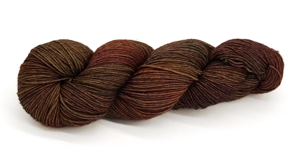 A skein of yarn mixing stormy charcoal, slate and green-black shades.