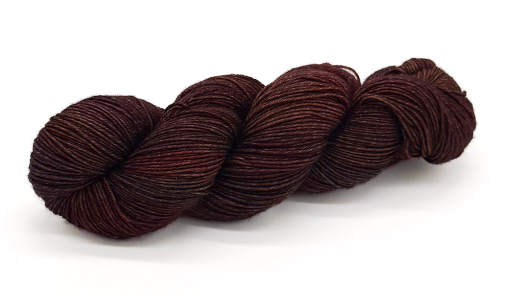 A skein of yarn combining rustic red-browns with hints of ember and cedar.