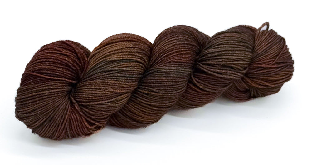 A skein of yarn in earthy browns and woodland-shaded tones.